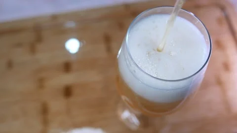 POV of someone pouring beer. Close-up of bubbles bursting in beer foam Stock Footage 332178356