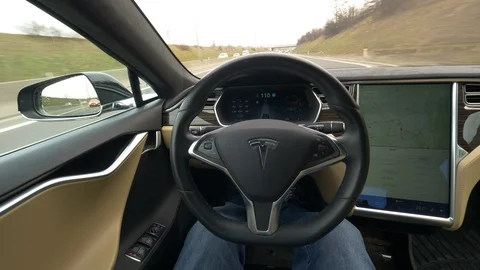 POV: Speeding down the highway without holding the steering wheel of a Tesla. Stock Footage 97728984