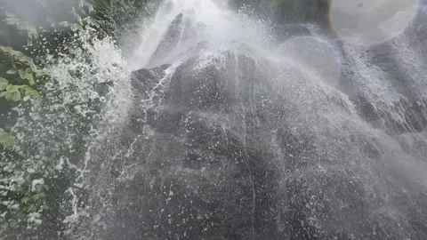POV standing under a tropical waterfall Stock Footage 220114302