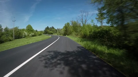 POV Sunny Day And Empty Road Among Trees And Meadows Stock Footage 126169783