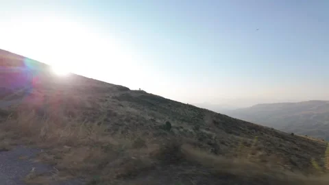 POV Sunset Driving Through Dry Mountainous Landscape Stock Footage 342330958