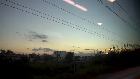 POV sunset from a moving train Stock Footage 240833254