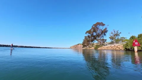 POV SUP glide past red marker Dana Point Harbor California clear day Stock Footage 331549372