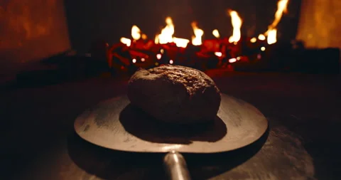 POV of taking out hot bread loaf out of traditional stone oven with burning Vídeos de archivo 154332051