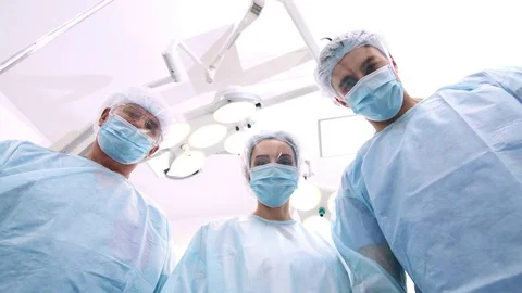 POV three doctors looking at the patient and put on breathing mask Stock Footage 82079275