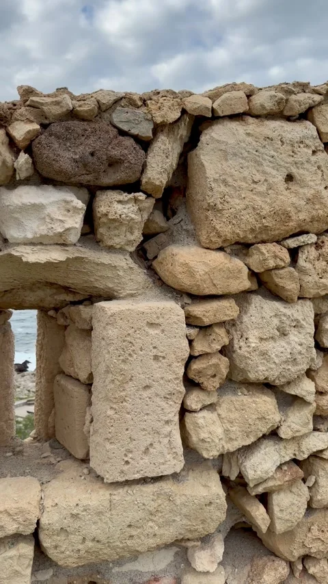 POV Through Fortezza Stone Embrasure to Coast in Rethymno Crete Stock Footage 346487129