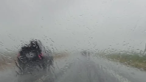 POV Through Rain Hitting Windshield On Highway Approaching Congestion Vídeos de archivo 297348396