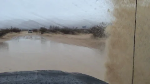 Pov through window going through mud puddle with big splash Stock Footage 301261525