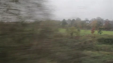 POV through Window Train Travels Past Suburban Scene Residential Houses Stock Footage 44520296
