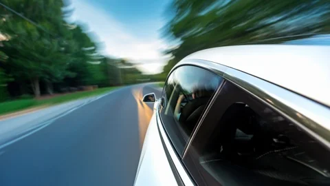 POV time-lapse of a white luxury vehicle driving Stock Footage