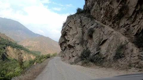POV timelapse camera on the car driving on a narrow gauge road in the highlands Stockbeeldmateriaal 198797482