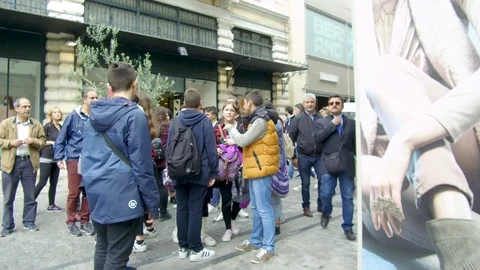 Pov tracking shot camera moves forward in main street among crowd of people Stock Footage 92440544