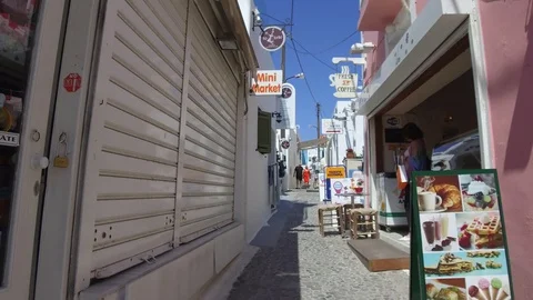Pov tracking shot camera moves forward uphill in a narrow alley of small town Stock Footage 92440891
