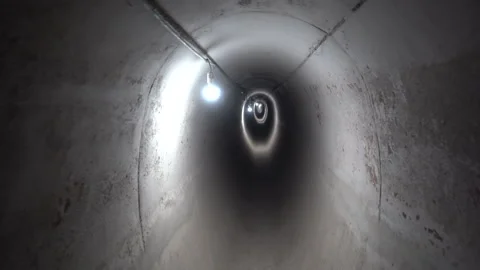 POV Tracking Shot Moving Through Dark Concrete Underground Utility Tunnel Vídeos de archivo 334940122