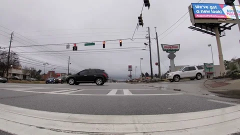 POV traffic close to the ground view Krispy Kreme and traffic at an intersect Stock Footage 148795345