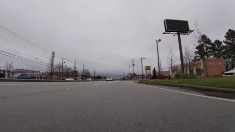 POV traffic close to the ground view Dollar General and urban scene Stock Footage 148795825