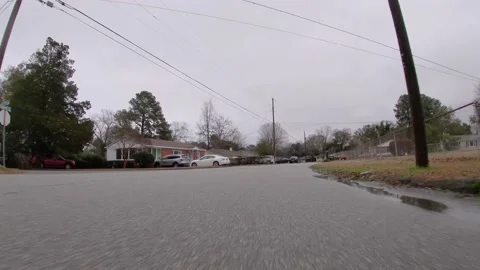 POV traffic close to the ground view 1950s neighborhood in Georgia old fences Stock Footage 148797953