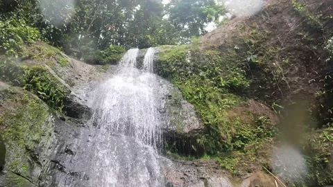 POV Turn around to view up at waterfall in Borneo Stock Footage 239497744