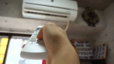 POV Of Turning On Air Conditioning With Remote Stock Footage 104477685