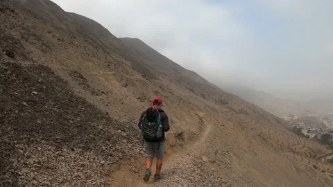 Pov two friends walking down a narrow path up a steep hill Stock Footage 145102486