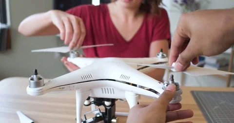 POV of two hands and young woman putting the propellers on a drone Stock Footage 84293137