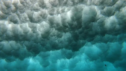POV from underwater of surfer surfing on foamy ocean waves, Bali Stock Footage