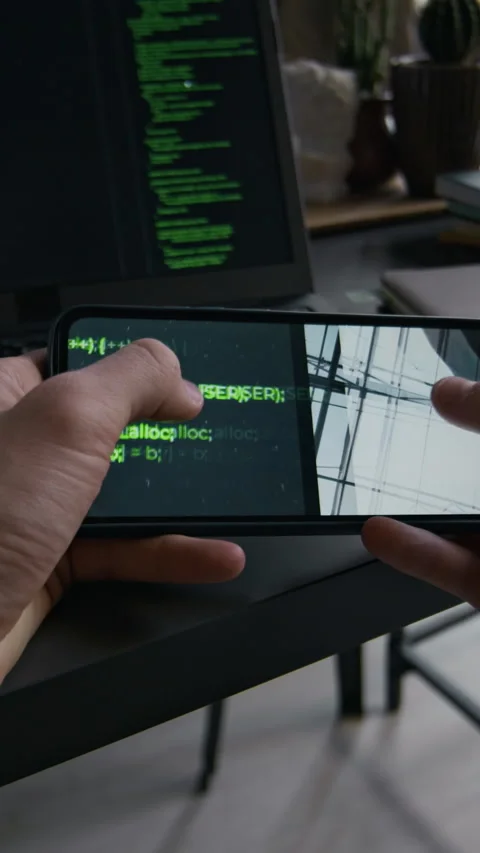 POV of Unrecognisable Developer Checking Code for Errors Holding Phone Stock Footage 299212235