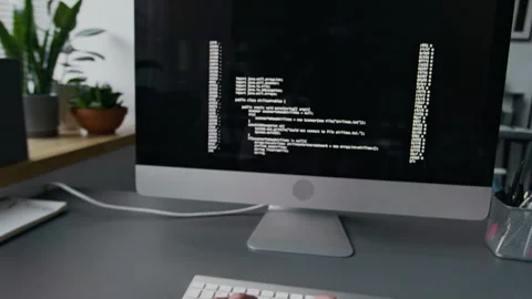 POV of Unrecognisable Man Coding on Computer during Workday at Office Desk Stock Footage 299688160