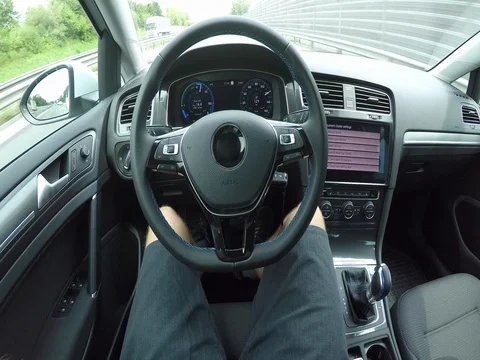 POV Unrecognizable man in self-steering autonomous electric car on highway Stock Footage