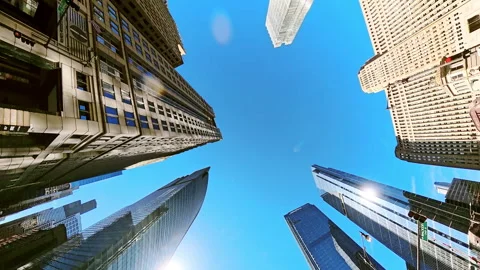POV of upward view between tall skyscrapers in Chicago. Blue sky is framed by Stock-Footage 321117611