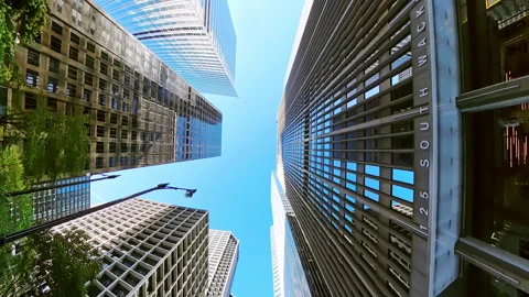 POV of upward view between tall skyscrapers in Chicago. The blue sky is framed Stock Footage 321450871