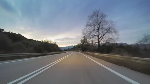 POV vehicle drive car travel tranquil remote countryside curvy road evening Stock Footage 71155036