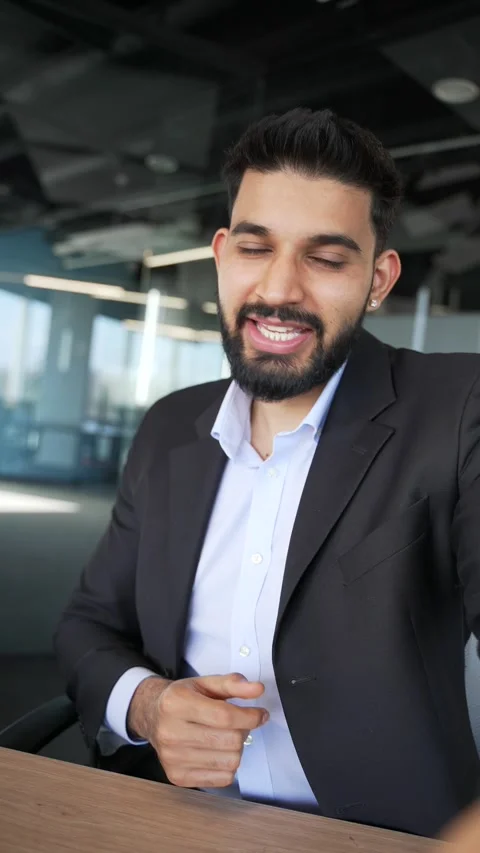 POV Vertical. Smiling businessman talking on video call using phone in office.  Stock Footage 334861803