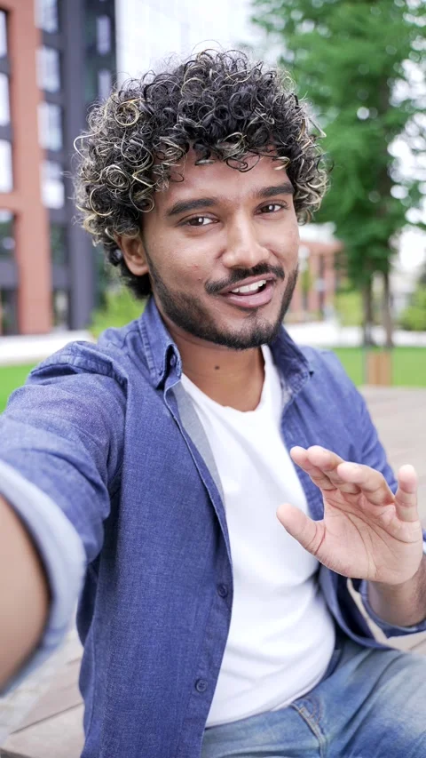 POV Vertical. Smiling student talking on a video call using a mobile phone while Stock Footage 317709537