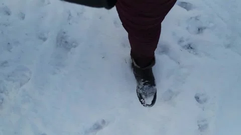 POV video of walking through fresh snow shows snow-covered winter boots Stock Footage 303774242