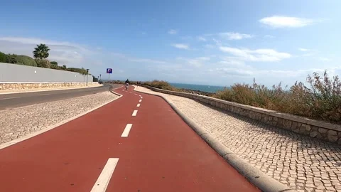 POV view of bike path next to sea in Cascais, Portugal Stock Footage 139570793