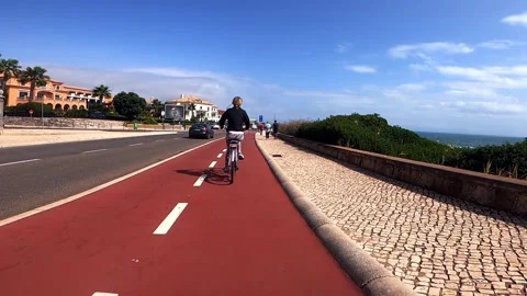 POV view of bike path next to sea in Cascais, Portugal Stock Footage 139570914