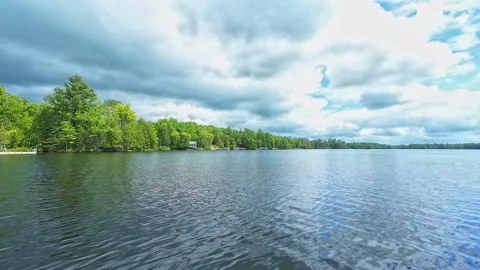 POV view from the boat bow of small lake with fir trees. Boating at cottage.. Stock Footage 291476997