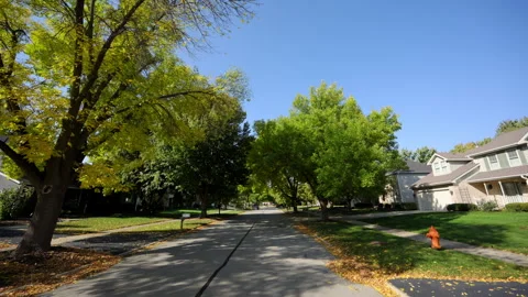 POV view from the car driving on small town streets at sunny autumn neighborhood 스톡 동영상 320920751