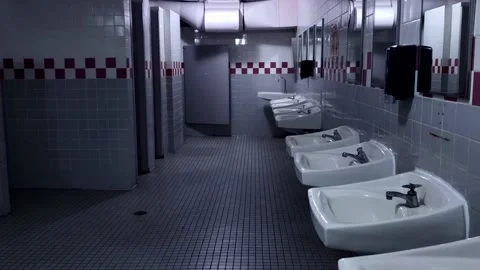 POV View of a Empty Men's Dark Restroom 4K Stock Footage 218403156