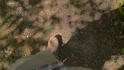 POV The view from the eyes is like feet in brown boots with red laces walking on Stock Footage