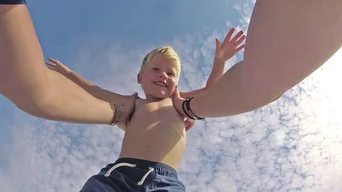 POV view. Happy father and son playing on tropical beach, carefree happy fun Stock Footage