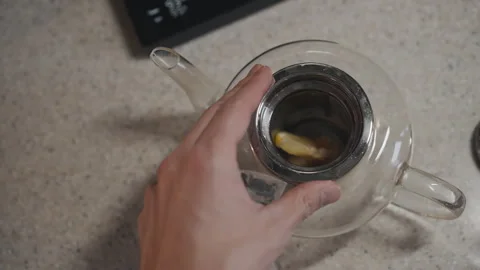 Pov view how Man putting tea bag in teapot with lemon Stock Footage 294253836