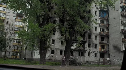 POV view from inside the car of the view of the bombed-out house Stock Footage 195838890