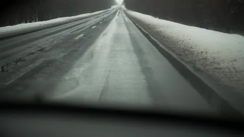 POV view from inside the car onto a wet road with melting snow. Stock Footage 263567232