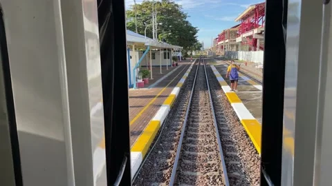 POV view moving local train sunny day leaving Hua Hin railway station sunny Video stock 221677326