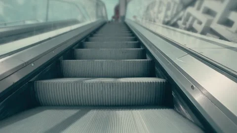 POV view riding an outdoor escalator with metal steps and glass sides Stock Footage 336732014
