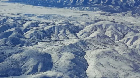 POV- View of snow covered mountains and hills from aircraft landing approach Stock Footage 59173360