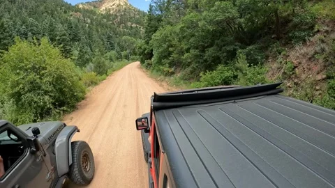 POV - View of vehicle rooftop driving on Phantom Canyon Road; driver waves Stock Footage 280221670