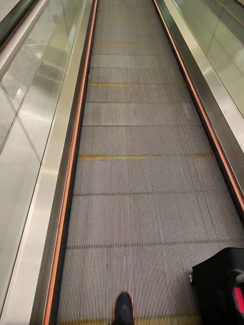 POV walking across the flat escalator Stock Footage 306735378